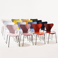 Colorful modern chairs in pastel pink, yellow, green, maroon, and black arranged in a stylish display.