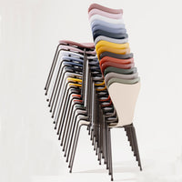 Stacked chairs showcasing a variety of vibrant colors and smooth, curved patterns against a neutral background.