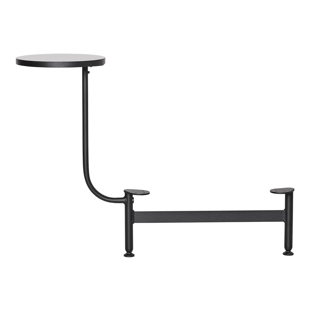 Black metal side table with a simple round top and curved leg design, showcasing a modern minimalist aesthetic.