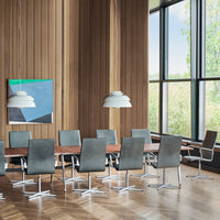 Modern conference room featuring gray upholstered chairs, wood table, and large windows with natural light.