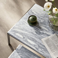 "Gray marble-patterned tabletop with subtle white streaks, complemented by a minimalist metal frame."