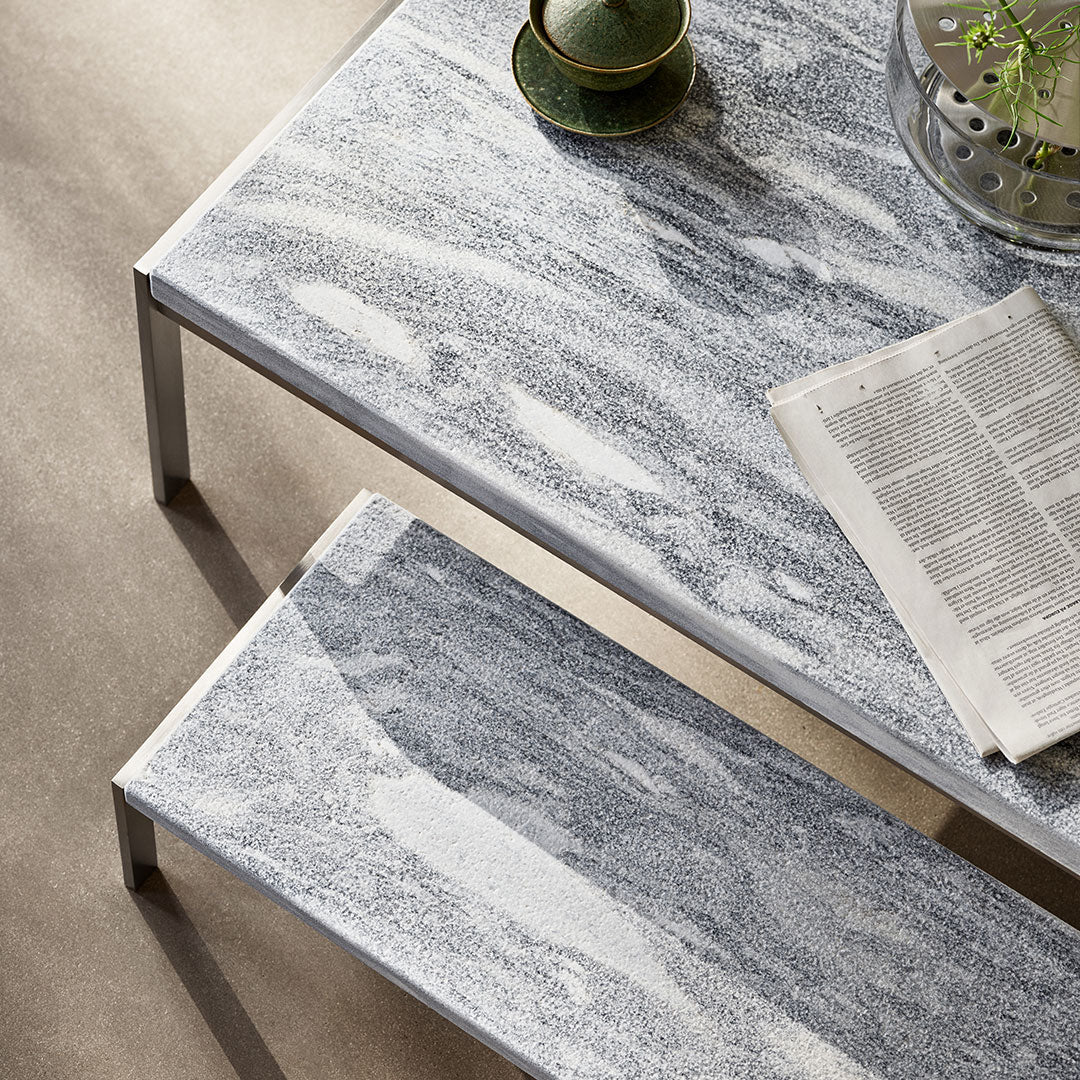 "Stylish gray and white marbled tabletop with sleek metallic legs, complemented by a minimalist design."