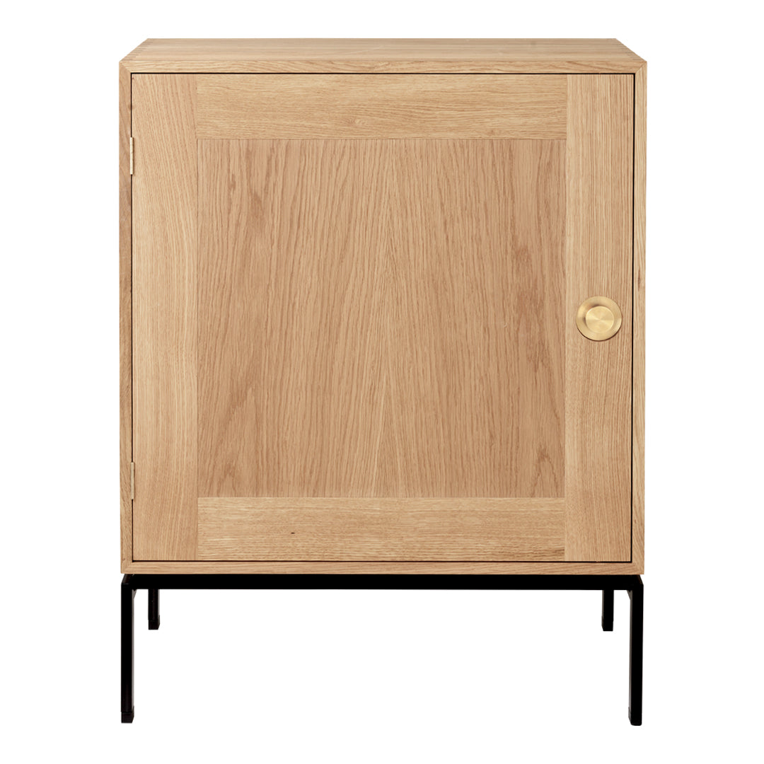 Natural oak finish with a smooth wood grain pattern, accented by a brass knob and black metal legs.
