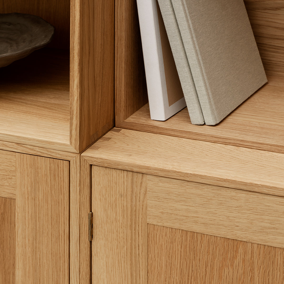 Natural oak finish with smooth surfaces, featuring clean lines and minimalist design. Neutral tones with subtle texture.