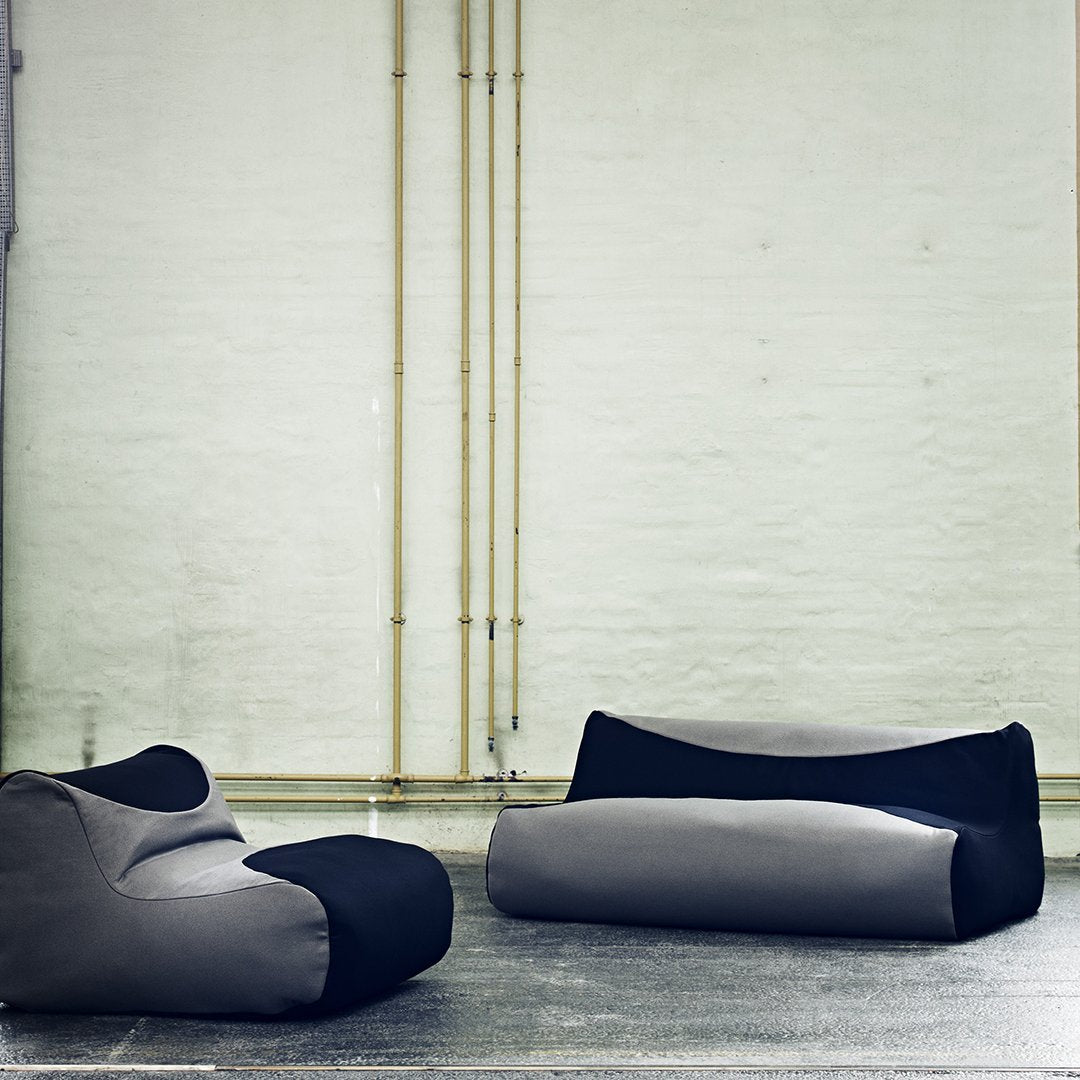 Gray and black bean bag chairs with sleek, modern patterns in minimalist industrial setting.