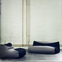 Gray and black bean bag chairs with sleek, modern patterns in minimalist industrial setting.