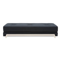 Dark navy upholstered sofa with tufted cushions and a sleek light-colored metal base, offering a modern design.