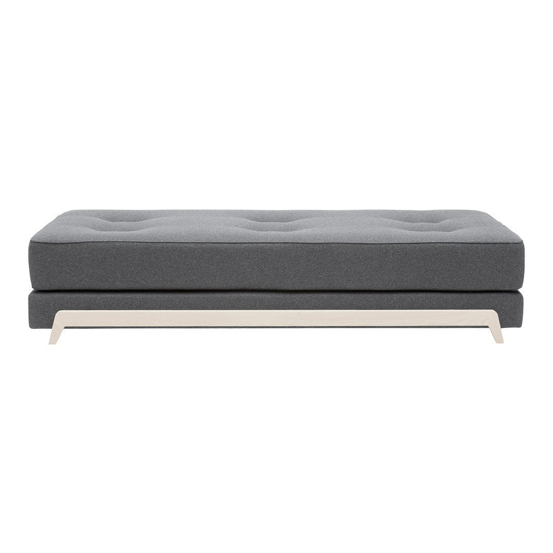 Gray upholstered sofa with tufted design and sleek beige wooden legs, perfect for modern interiors.