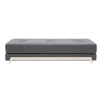 Gray upholstered sofa with tufted design and sleek beige wooden legs, perfect for modern interiors.