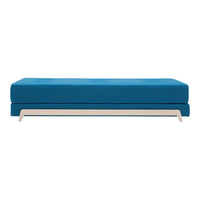 Vibrant blue sofa with smooth cushions and sleek white base. Modern design perfect for any stylish living space.