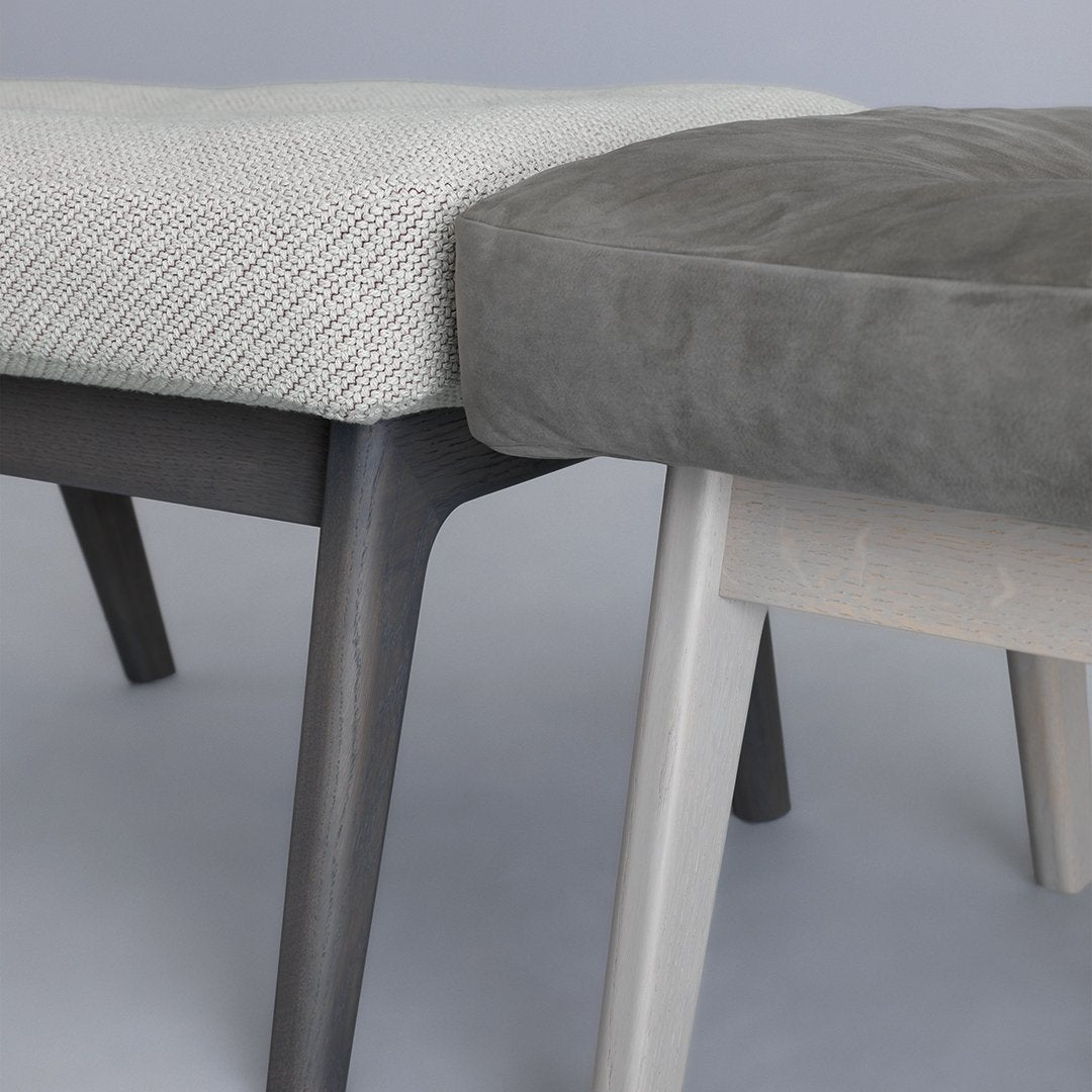 Gray and white patterned upholstery on modern benches with sleek wooden legs, showcasing a stylish color contrast.