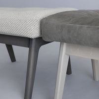 Gray and white patterned upholstery on modern benches with sleek wooden legs, showcasing a stylish color contrast.