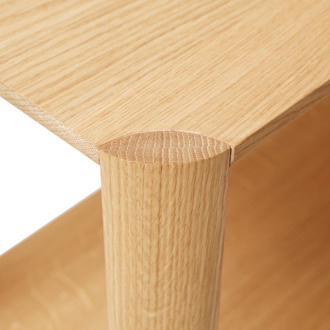Light oak wood surface with a smooth finish and subtle grain pattern, showcasing natural warmth and texture.