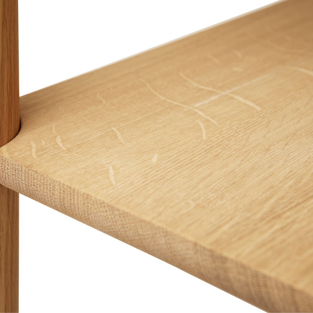 Light oak wood shelf with subtle grain patterns and natural finish, showcasing scratches and character marks.