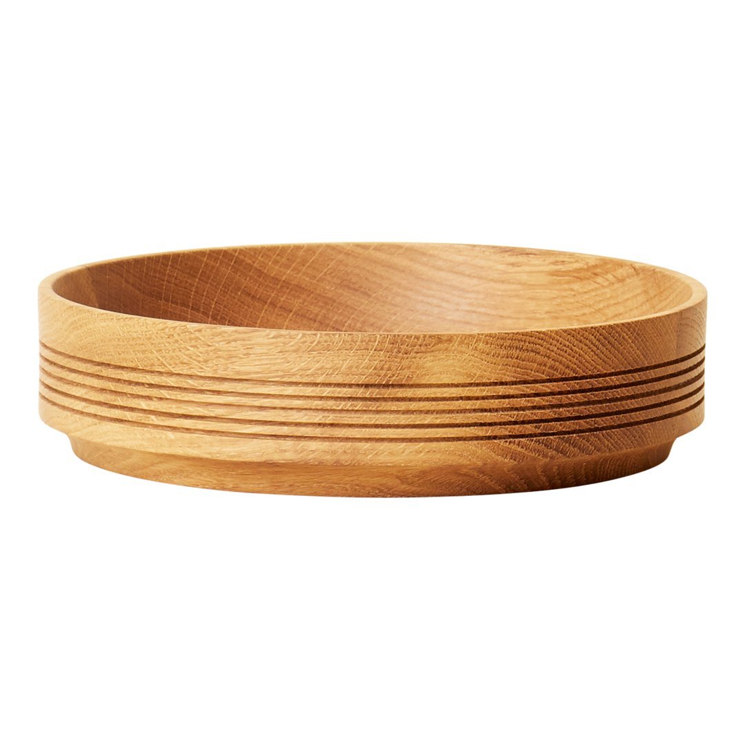 Natural wooden bowl with a smooth finish and subtle grooved pattern in light brown hues. Perfect for home decor.