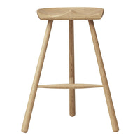 Natural wood stool with a smooth light oak finish and simple design, featuring three tapered legs.