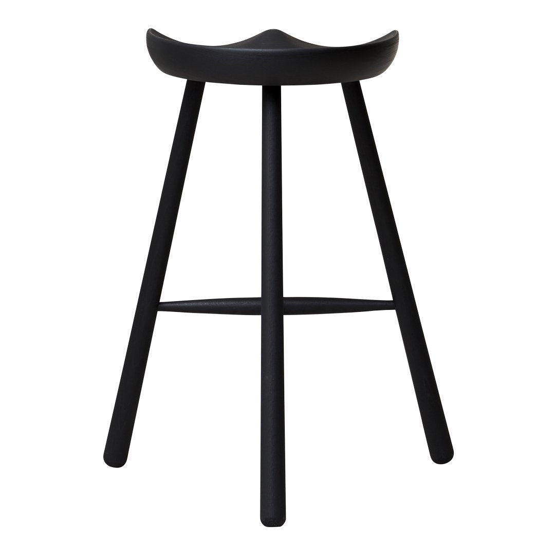 Black wooden stool with a minimalist design, featuring a smooth, curved seat and slender legs.