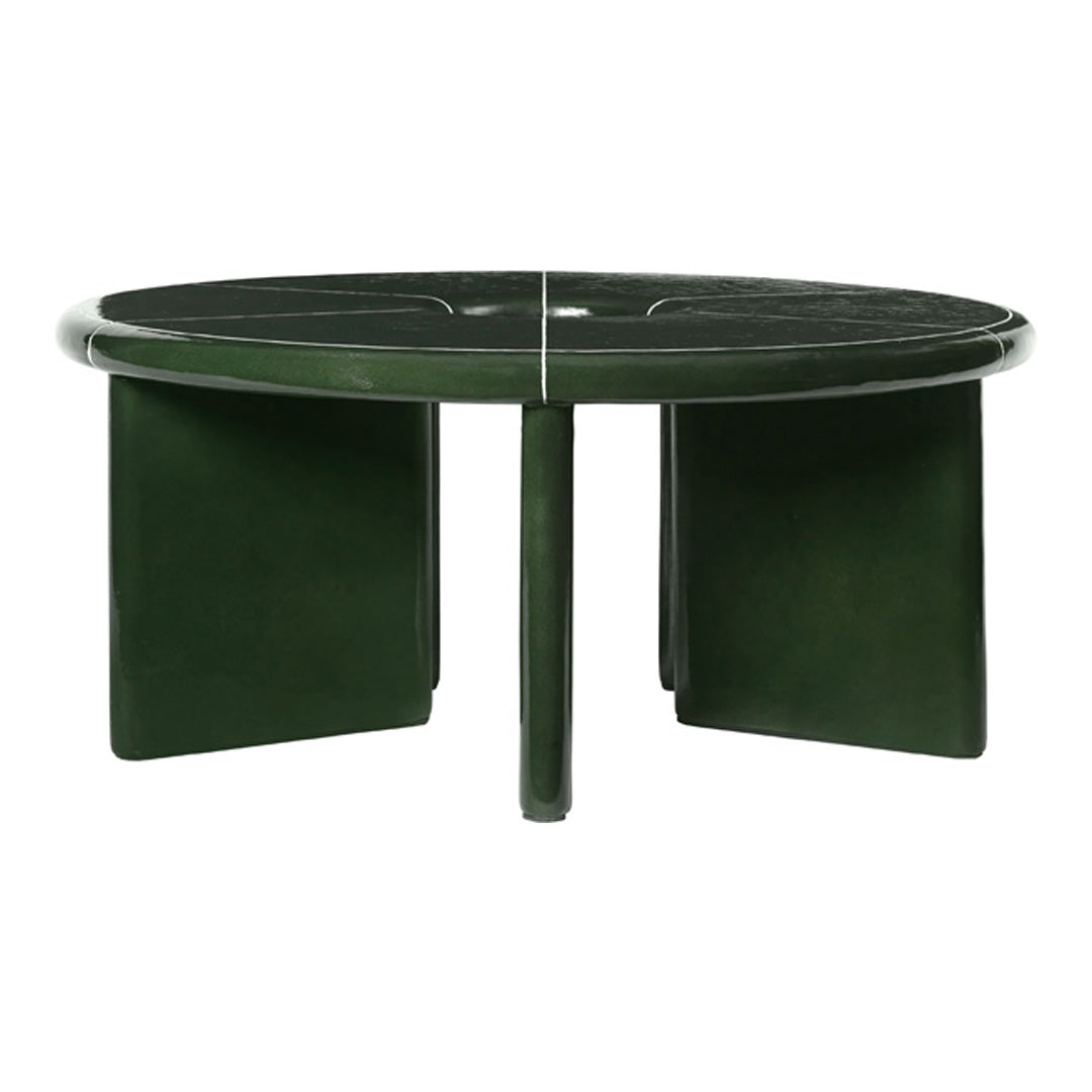 Round coffee table in deep green with a sleek, glossy finish and minimalist design. Smooth, modern surface pattern.