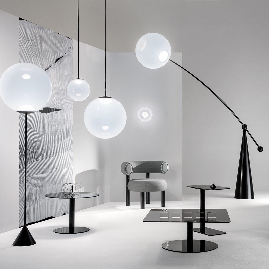 Modern black and white lighting fixtures with clear glass globes and minimalistic design in a sleek, contemporary setting.
