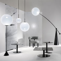 Modern lighting design with white globes, sleek black bases, and minimalist patterns against a light gray backdrop.