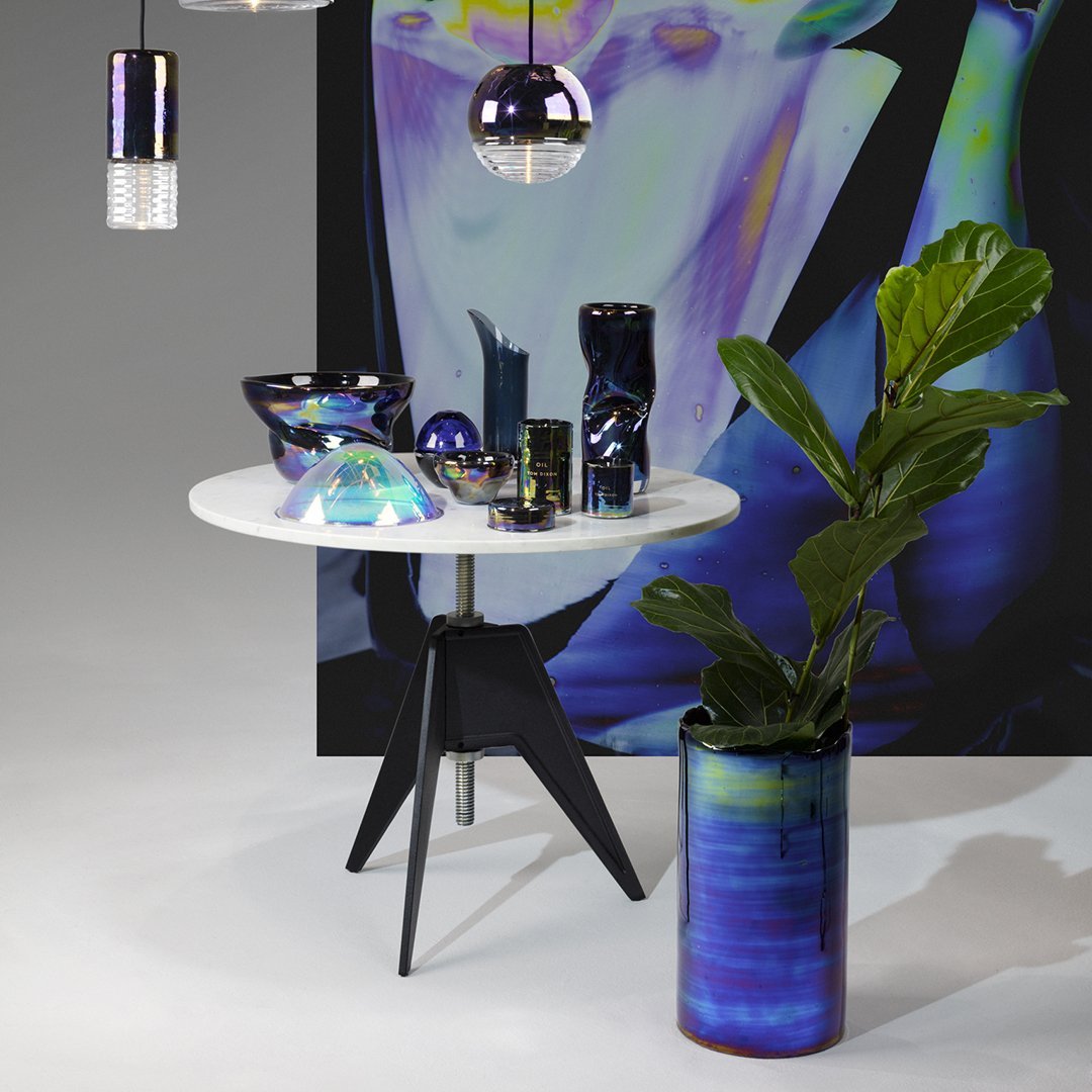 "Glossy iridescent decor in blue and purple hues, featuring geometric patterns against a modern tabletop and backdrop."