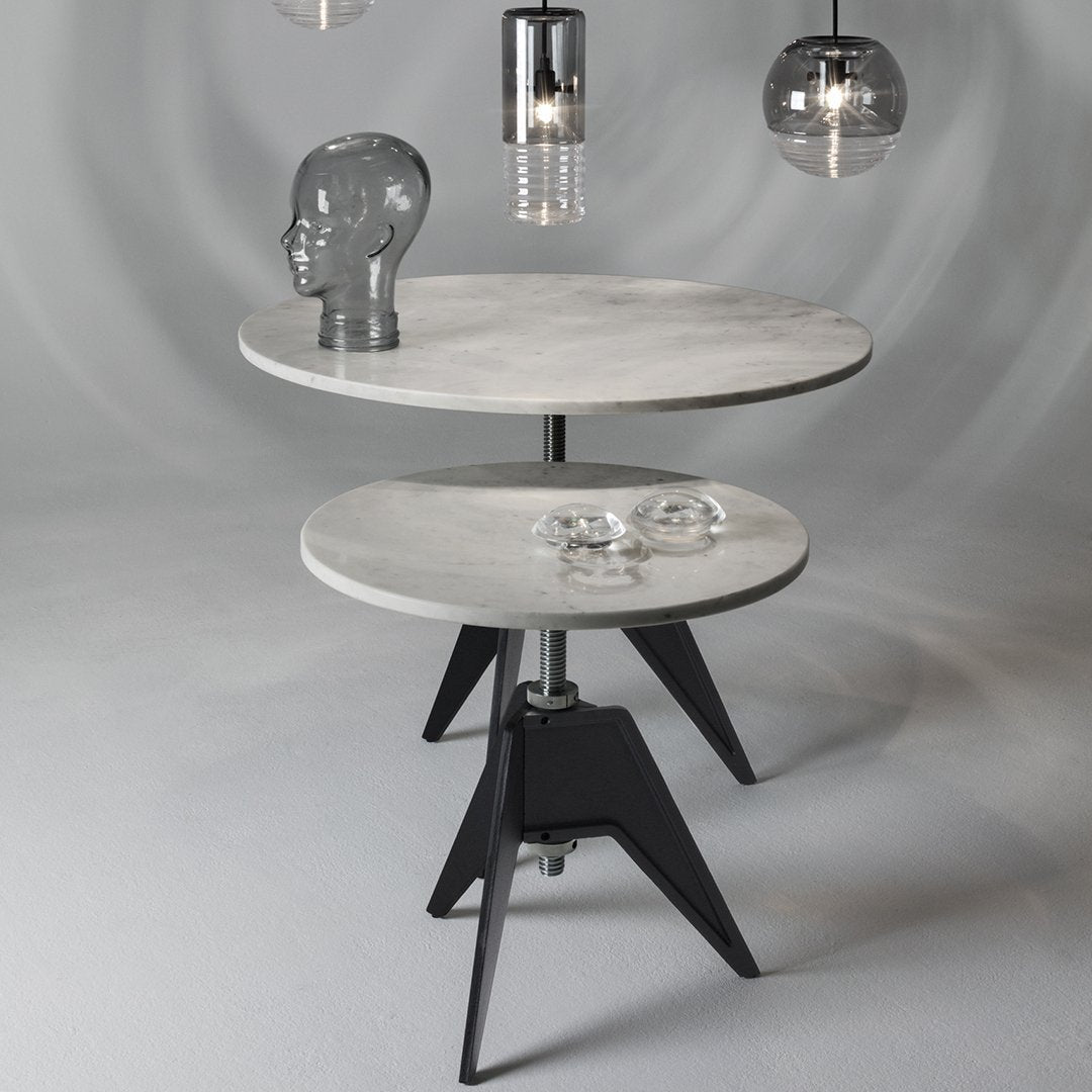 Round marble tables with gray and white tops, featuring sleek black bases and modern geometric design.