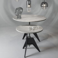 Round marble tables with gray and white tops, featuring sleek black bases and modern geometric design.