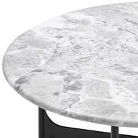 Round marble tabletop featuring a white and gray marbled pattern with subtle veining, complemented by a sleek black base.
