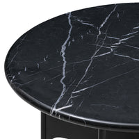 Round black marble tabletop with striking white veining, perfect for modern decor.