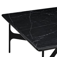 Black marble tabletop with white veining pattern, set on a sleek black metal base. Ideal for modern decor.
