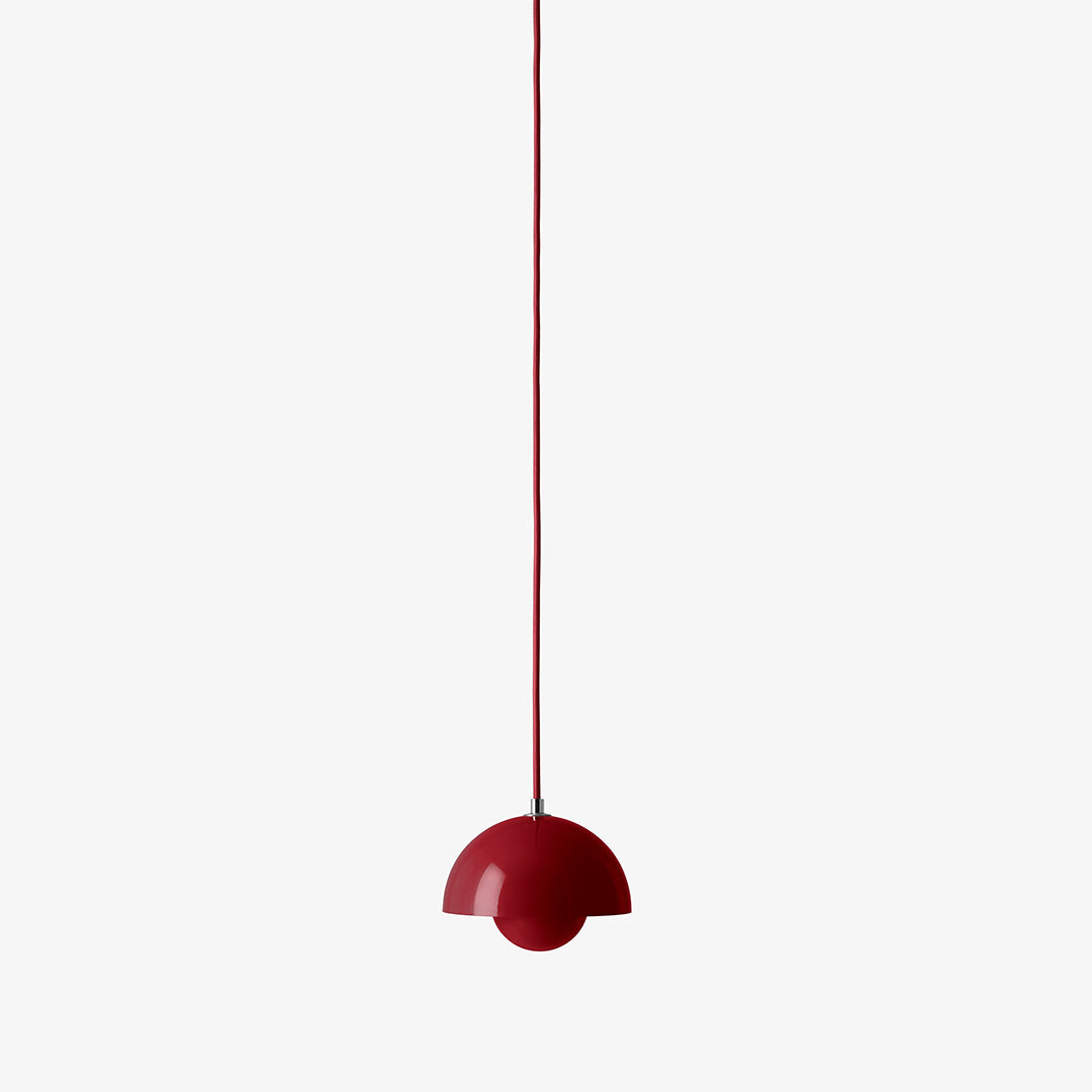 Red half-dome pendant lamp with a sleek, glossy finish, hanging from a thin red cord against a white background.