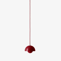 Red half-dome pendant lamp with a sleek, glossy finish, hanging from a thin red cord against a white background.
