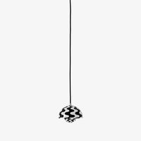 Black and white pendant light with wavy pattern, hanging from a thin black cord.