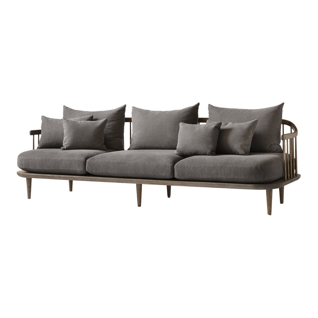 Grey upholstered sofa with multiple cushions and a wooden frame, showcasing a minimalist design and neutral tones.