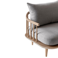 Light grey fabric sofa with plush cushions, featuring a natural wood frame and sleek, minimalist design.
