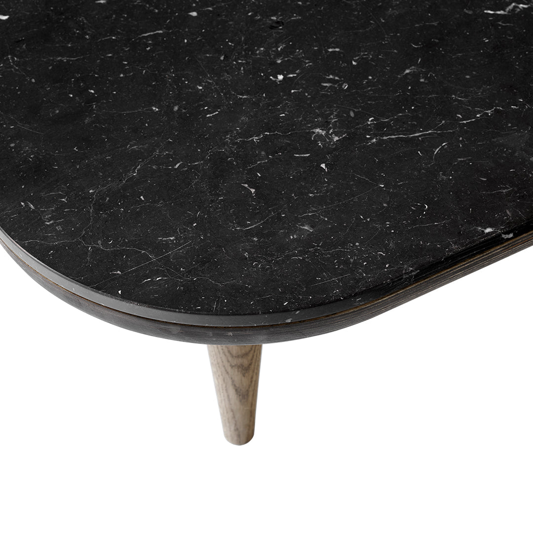 Black marble tabletop with white veining, complemented by natural wood legs in a sleek, modern design.