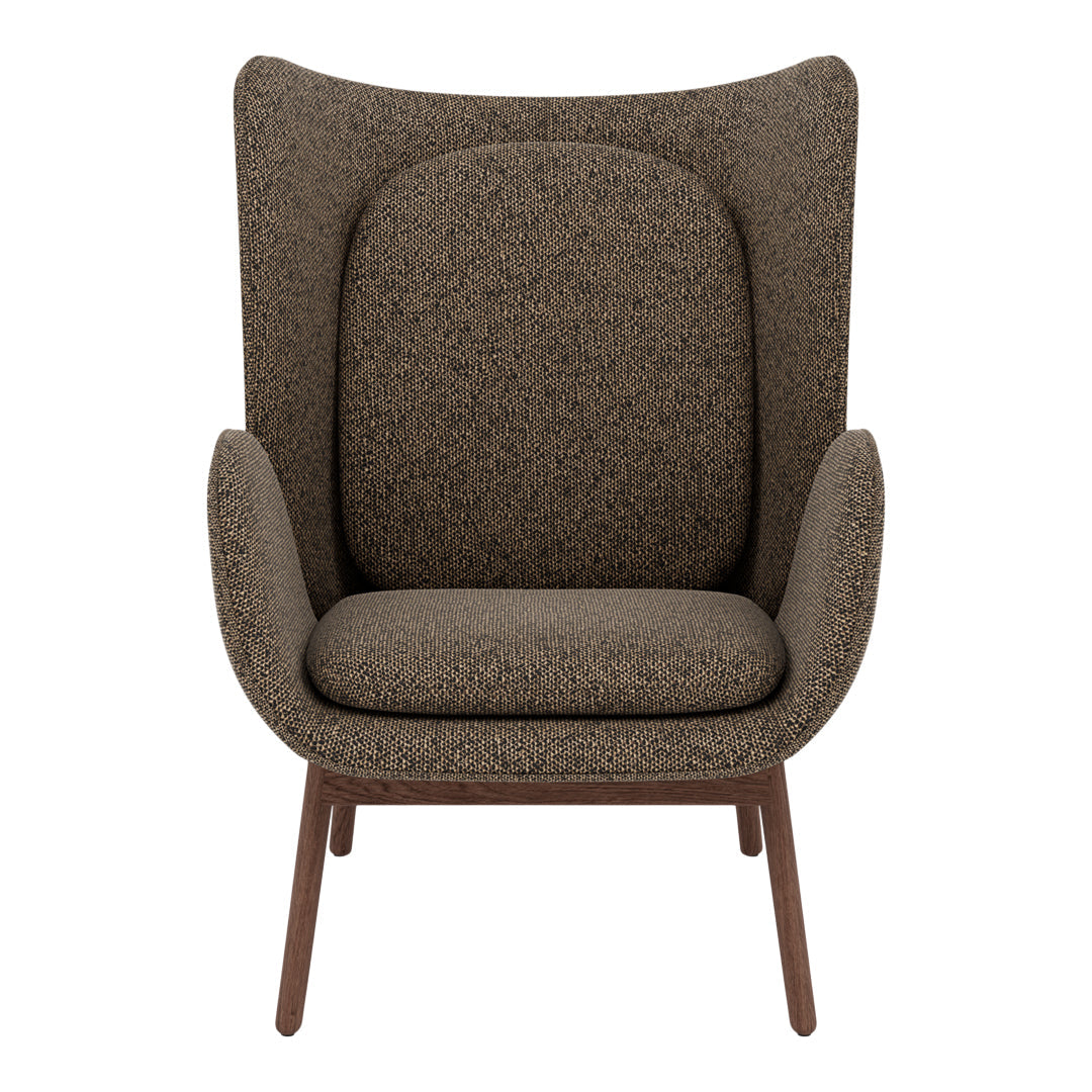 Brown patterned accent chair with a modern silhouette and tapered wooden legs. Soft, textured upholstery.