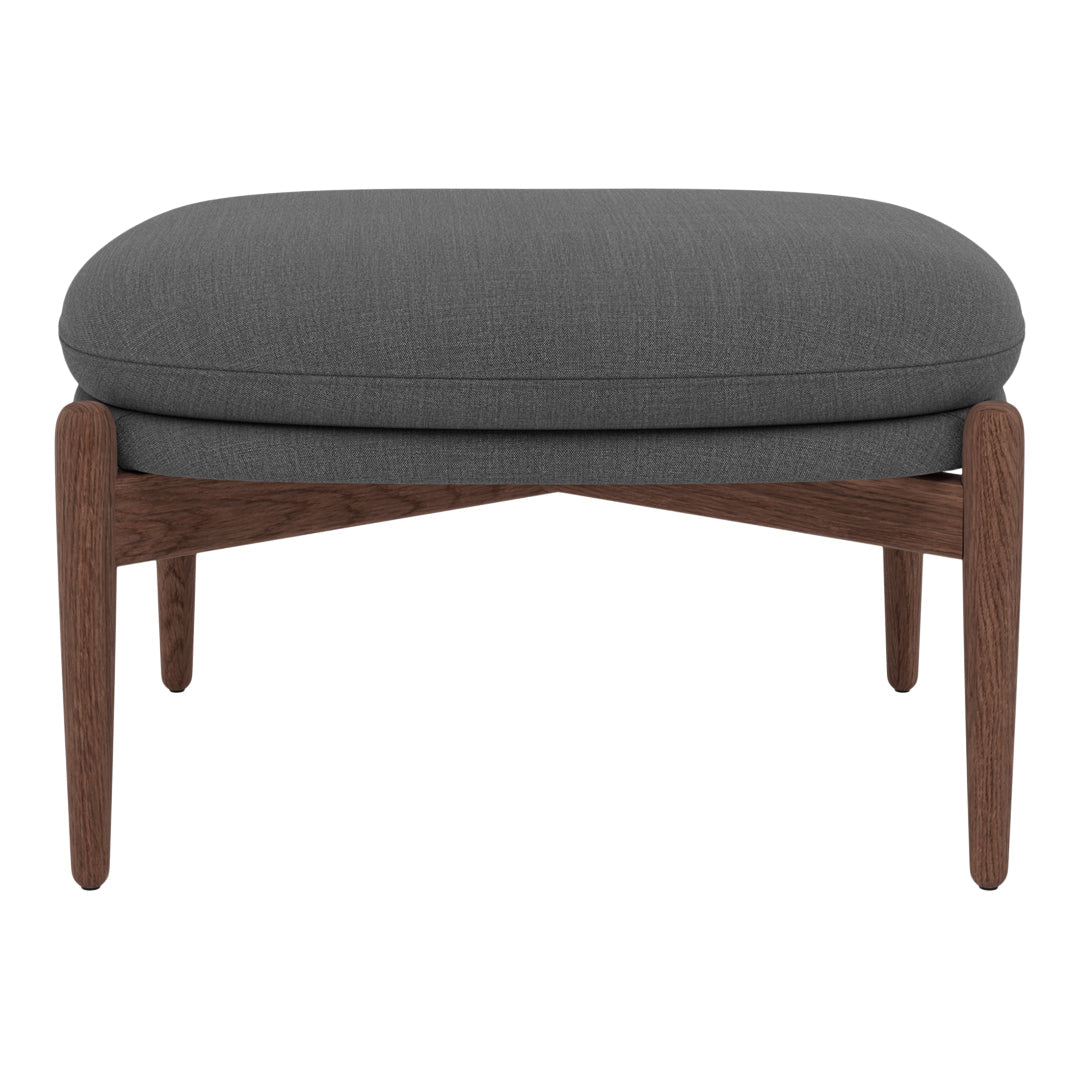 Gray upholstered ottoman with a smooth fabric pattern and wooden legs in a rich walnut finish.