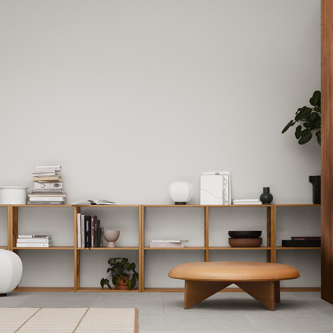 Minimalist wooden shelf with light beige and white decor, featuring natural wood tones and soft, neutral colors.
