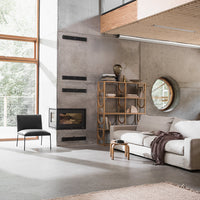 Stylish modern living room featuring neutral tones, sleek black chair, and earthy patterns in decor.
