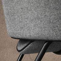 Gray textured fabric with a subtle pattern, complemented by sleek black metal legs. Perfect for modern decor.