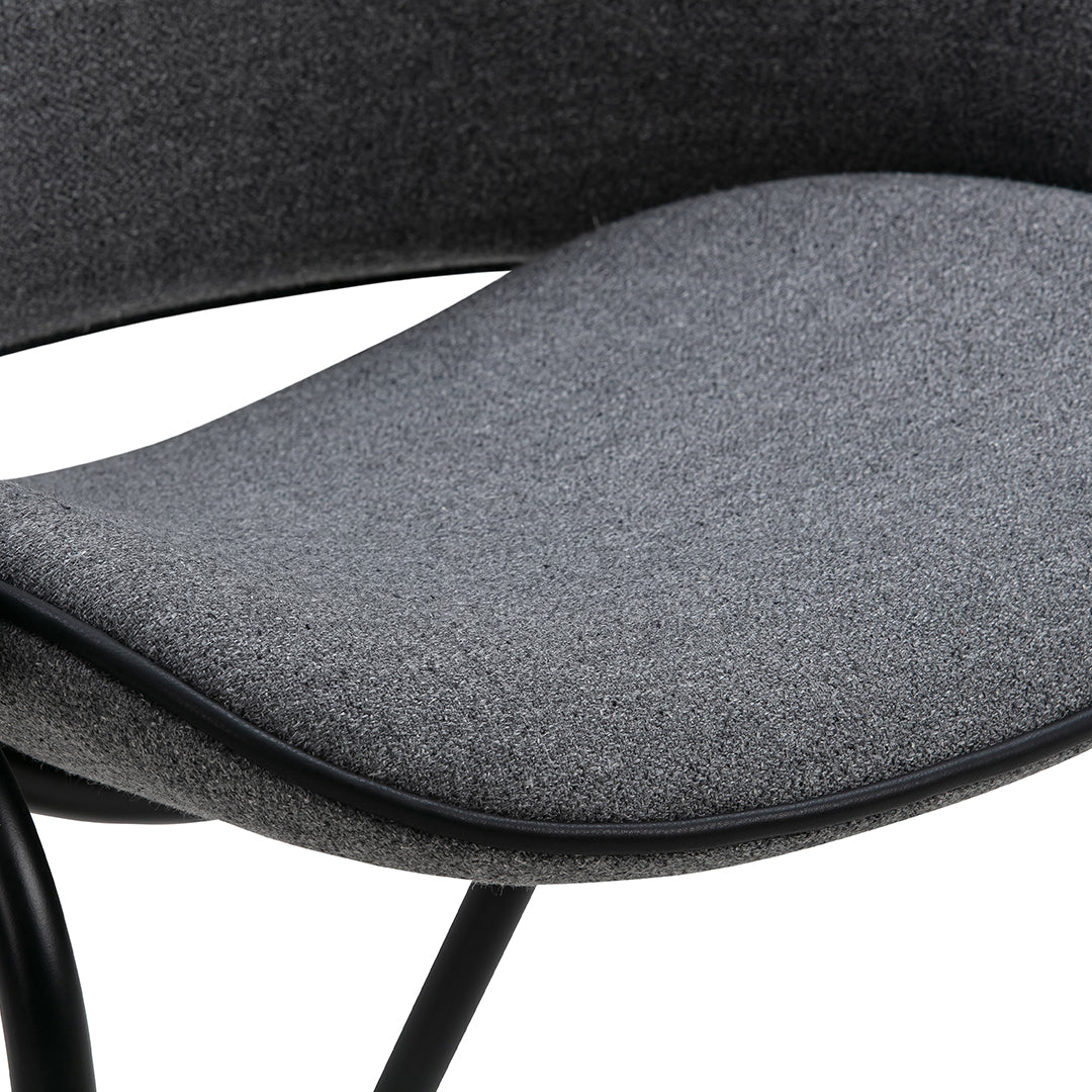 Gray textured fabric chair seat with a smooth curved design and black metal legs. Elegant and modern look.