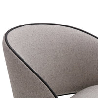 Gray fabric chair with a smooth texture and contrasting black piping trim. Stylish and modern design element.