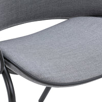 Gray textured fabric seat with smooth curves and black metal frame, perfect for modern decor.
