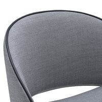 Gray upholstered chair with a smooth texture and black piping detail, featuring a modern, curved design.