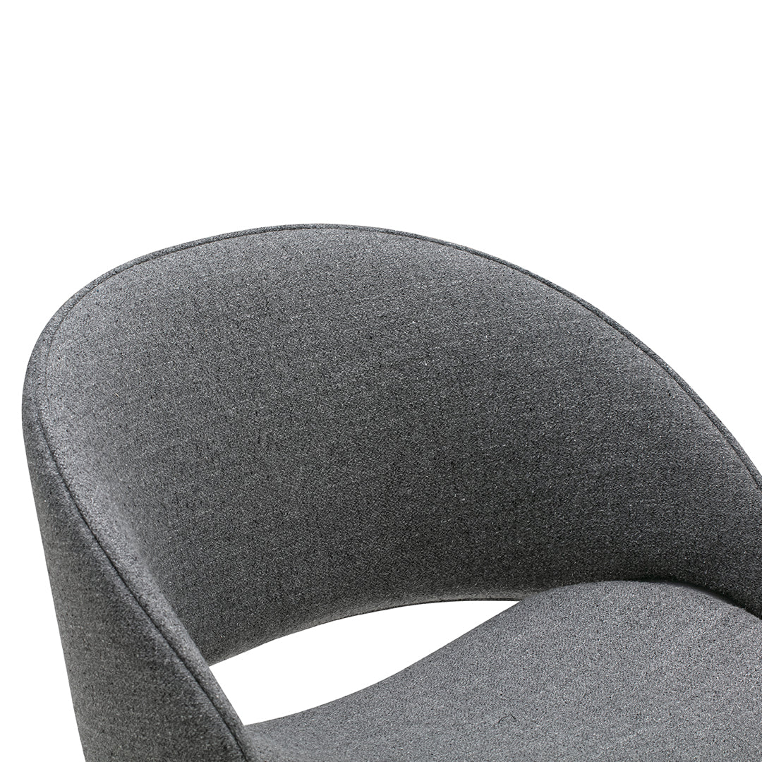 Gray upholstered chair with a smooth, curved design and subtle textured pattern. Perfect for modern interiors.