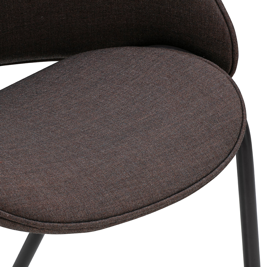Brown textured upholstery with a smooth finish, featuring a sleek modern design and black metal legs.
