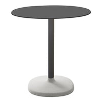 Round black table with a sleek gray base, featuring a minimalist design for modern decor.