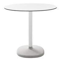 White round table with a smooth surface and a gray base, featuring a minimalist design and solid colors.