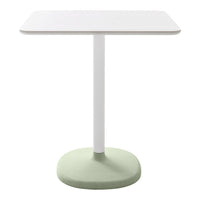 Square white tabletop with a smooth finish, supported by a minimalist green base. Modern, clean design.